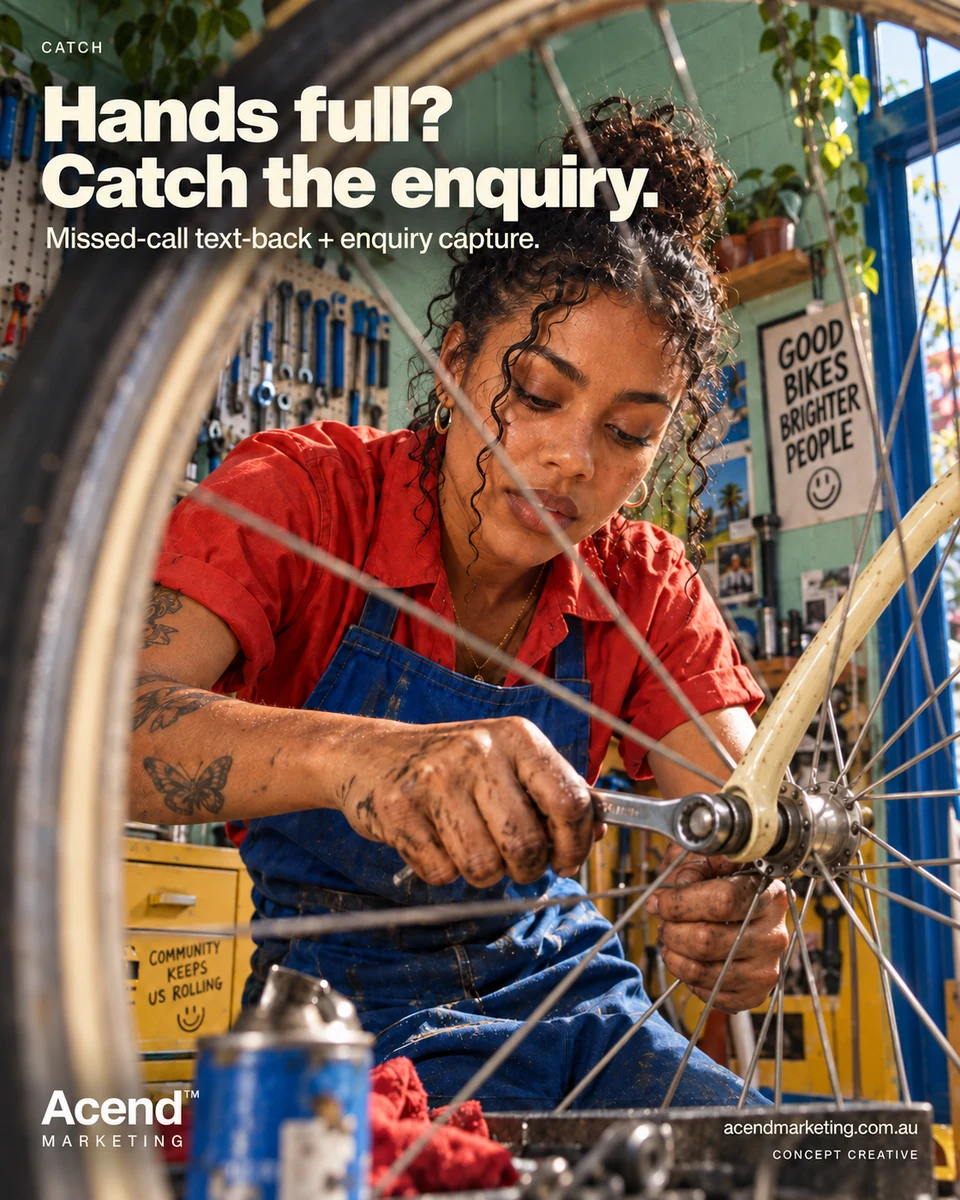 Concept photograph through a bicycle wheel of a mechanic in a red shirt and cobalt apron using a spanner on the front-wheel hub, with grease-marked hands and workshop tools behind her. Acend Catch: “Hands full? Catch the enquiry.” Missed-call text-back and enquiry capture.